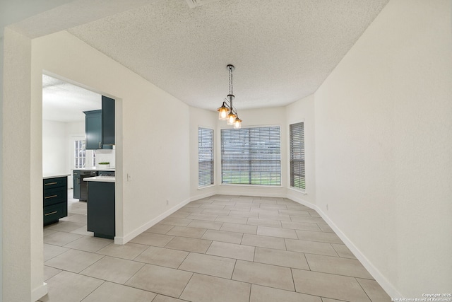 unfurnished dining area featuring a textured ceiling, an inviting chandelier, and light tile patterned flooring