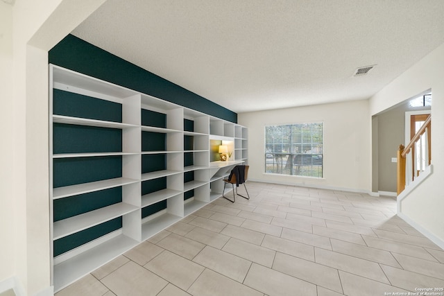 interior space featuring a textured ceiling