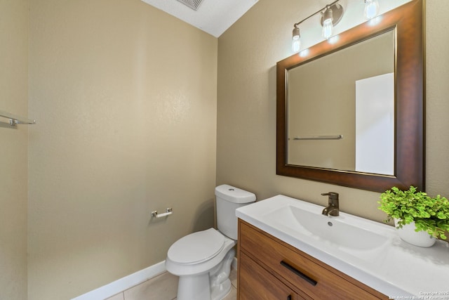 bathroom with tile patterned floors, toilet, and vanity