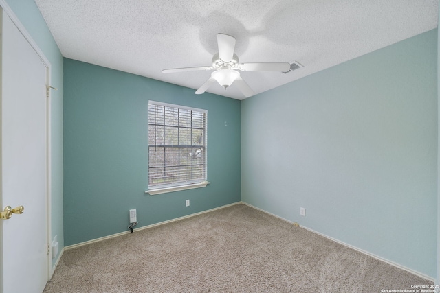 carpeted empty room featuring ceiling fan and a textured ceiling