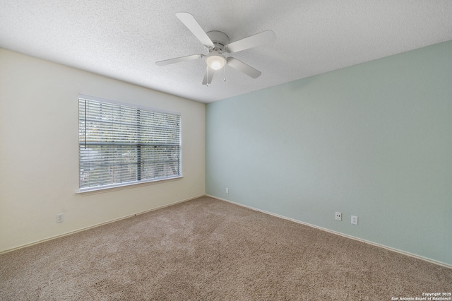 empty room featuring carpet, ceiling fan, and a textured ceiling