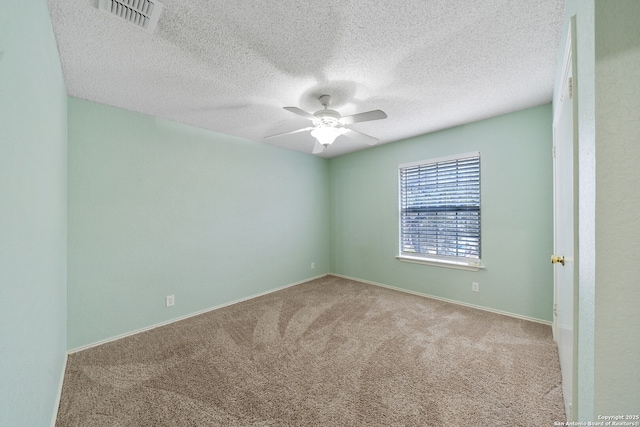 carpeted empty room with a textured ceiling and ceiling fan