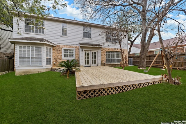 rear view of house featuring a wooden deck, a yard, french doors, and central air condition unit