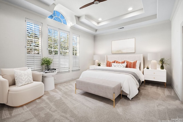 carpeted bedroom featuring a tray ceiling, ceiling fan, and crown molding