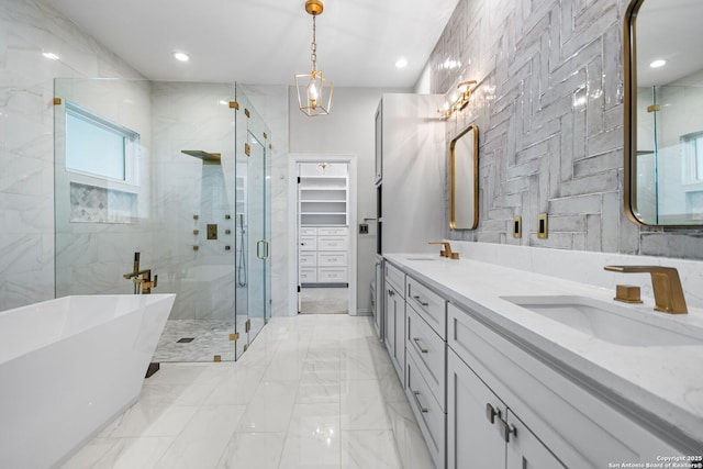 bathroom featuring separate shower and tub and vanity