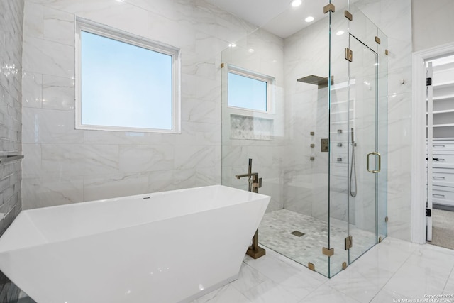 bathroom featuring separate shower and tub