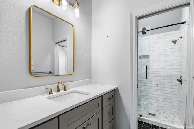 bathroom featuring tile patterned floors, vanity, and a shower with shower door