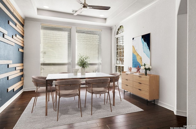 dining room featuring a tray ceiling, breakfast area, and ornamental molding