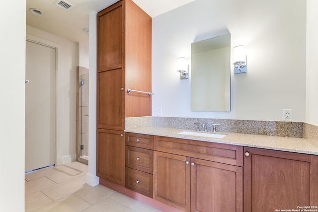 bathroom featuring tile patterned flooring and vanity