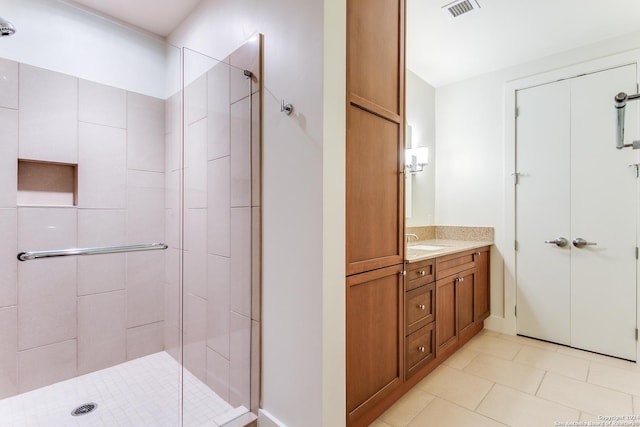 bathroom featuring walk in shower, tile patterned floors, and vanity