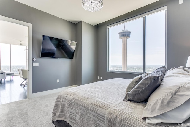 bedroom with an inviting chandelier and carpet