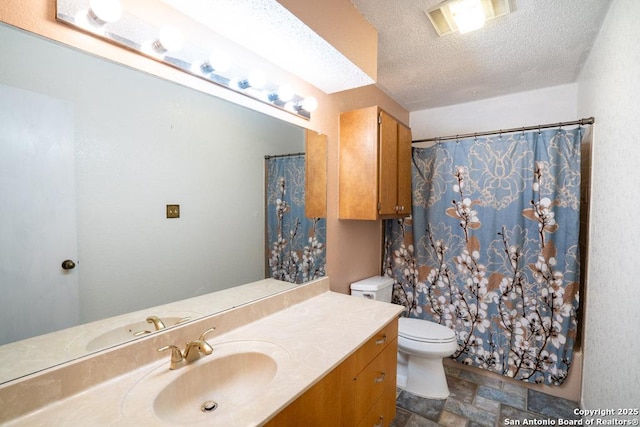 bathroom with a textured ceiling, toilet, vanity, and a shower with curtain