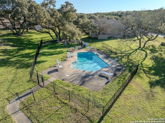 view of pool featuring a yard and a patio