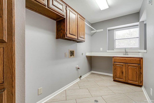 clothes washing area with gas dryer hookup, sink, cabinets, and washer hookup