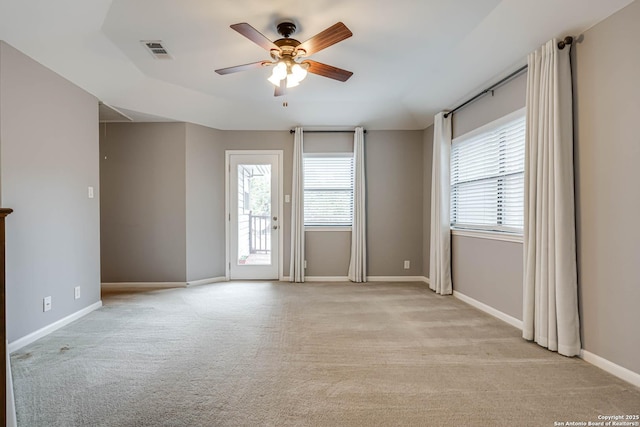 carpeted empty room featuring ceiling fan