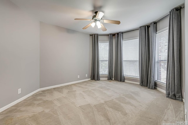 carpeted empty room featuring ceiling fan and a healthy amount of sunlight