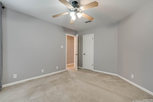 carpeted spare room with ceiling fan