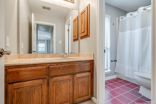 full bathroom with tile patterned flooring, vanity, toilet, and shower / bathtub combination with curtain