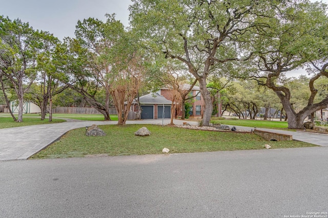 view of front of property featuring a garage and a front lawn