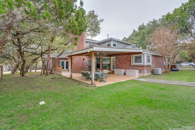 rear view of house with a yard, a patio, and central AC unit