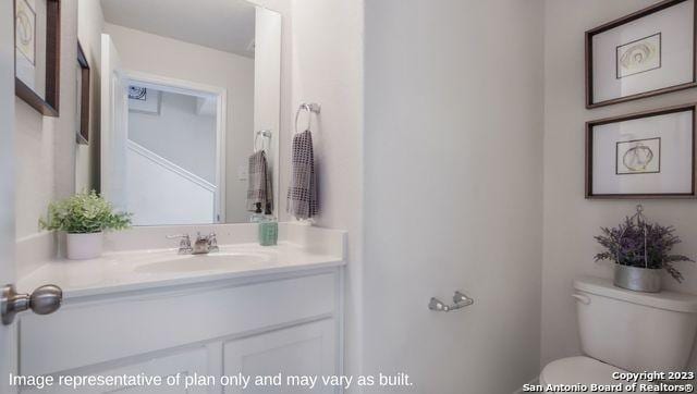 bathroom featuring vanity and toilet