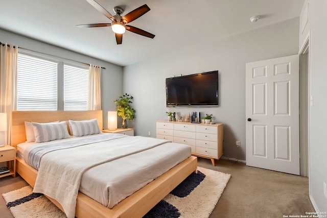 bedroom with ceiling fan and light colored carpet