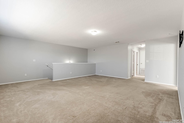 spare room featuring light colored carpet