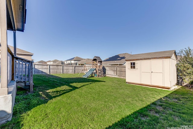 view of yard with a playground and a storage shed