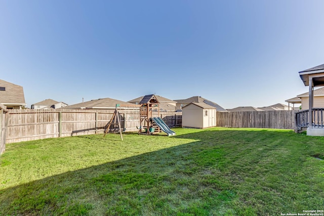 view of yard featuring a playground and a shed