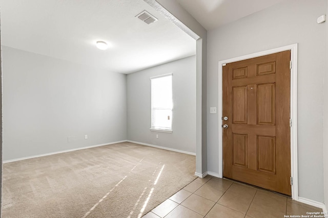 entryway with light tile patterned floors