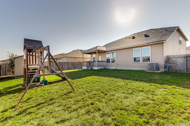 view of yard featuring a playground and central AC