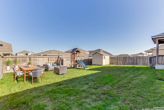 view of yard featuring an outdoor hangout area, a shed, and a playground