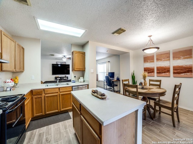 kitchen with sink, black range with electric cooktop, stainless steel dishwasher, kitchen peninsula, and pendant lighting