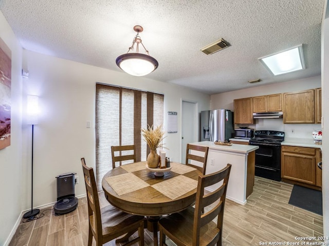 dining space with a textured ceiling