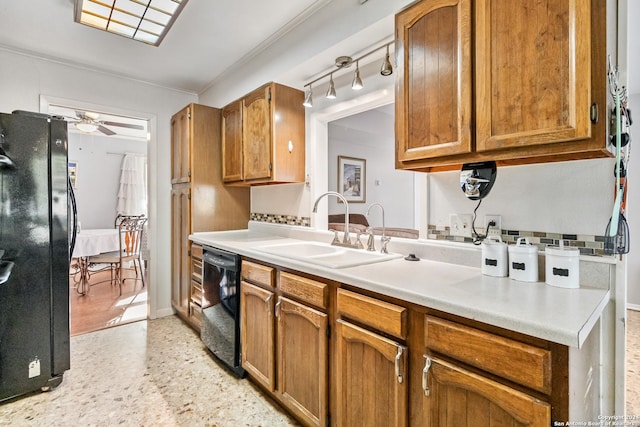 kitchen with black appliances, ceiling fan, and sink