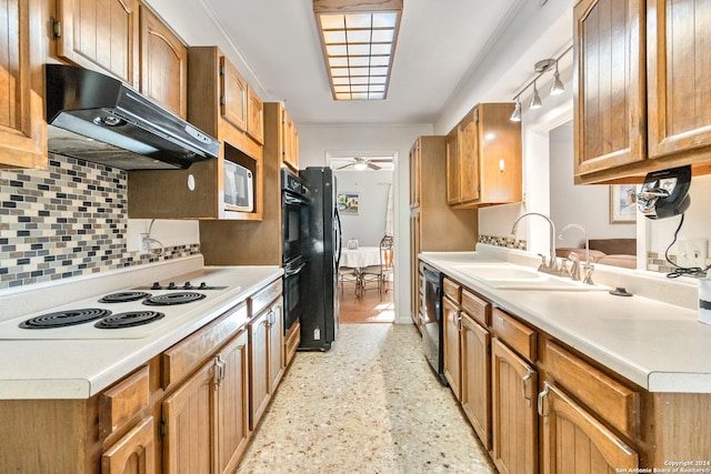 kitchen featuring black appliances, ceiling fan, sink, and backsplash