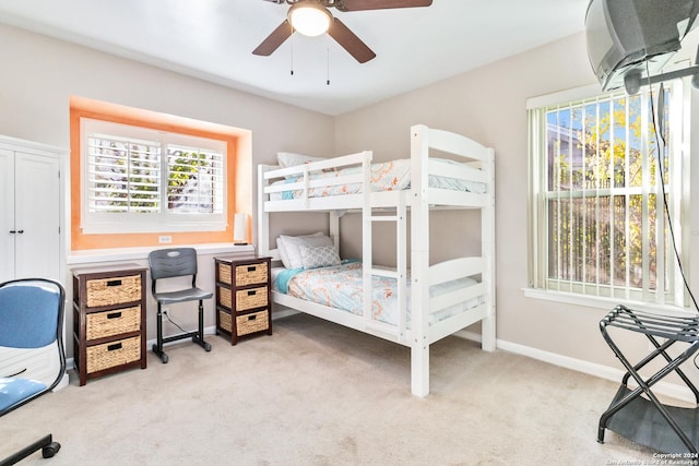 bedroom with ceiling fan and light carpet