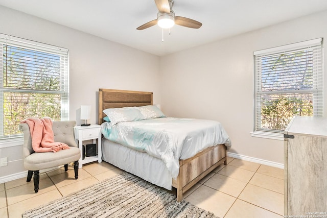 tiled bedroom with multiple windows and ceiling fan