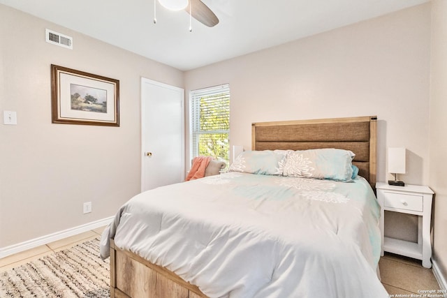 bedroom with ceiling fan and light tile patterned flooring