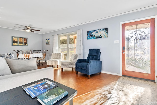 living room with ceiling fan, crown molding, and hardwood / wood-style flooring