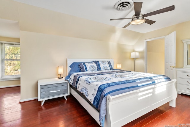 bedroom featuring ceiling fan, dark hardwood / wood-style flooring, and vaulted ceiling