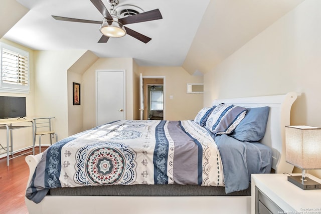 bedroom featuring hardwood / wood-style flooring, vaulted ceiling, and ceiling fan