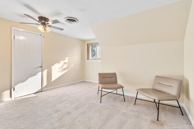 living area with light carpet, ceiling fan, and lofted ceiling