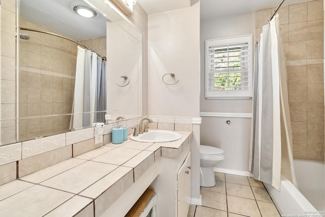 full bathroom with tile patterned flooring, vanity, toilet, and shower / bath combo with shower curtain