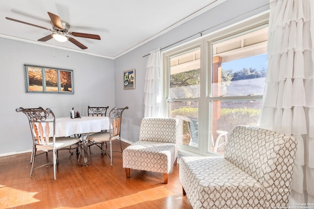 dining area with hardwood / wood-style flooring, ceiling fan, and crown molding