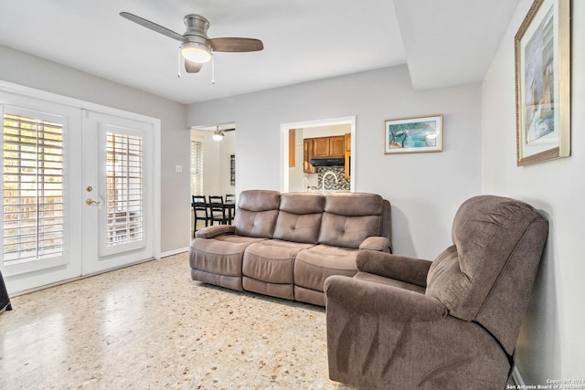 living room featuring ceiling fan and french doors