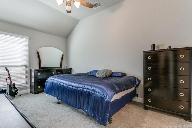 carpeted bedroom with ceiling fan and vaulted ceiling