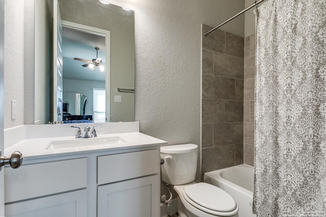 full bathroom featuring ceiling fan, vanity, shower / tub combo, and toilet