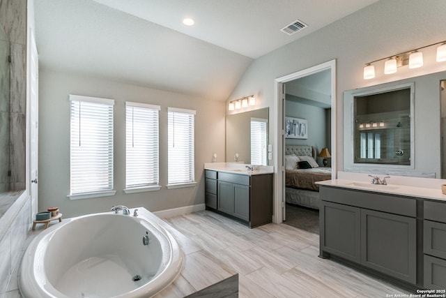 bathroom featuring vanity and lofted ceiling