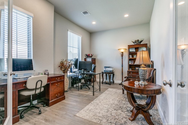 home office featuring french doors and light hardwood / wood-style floors